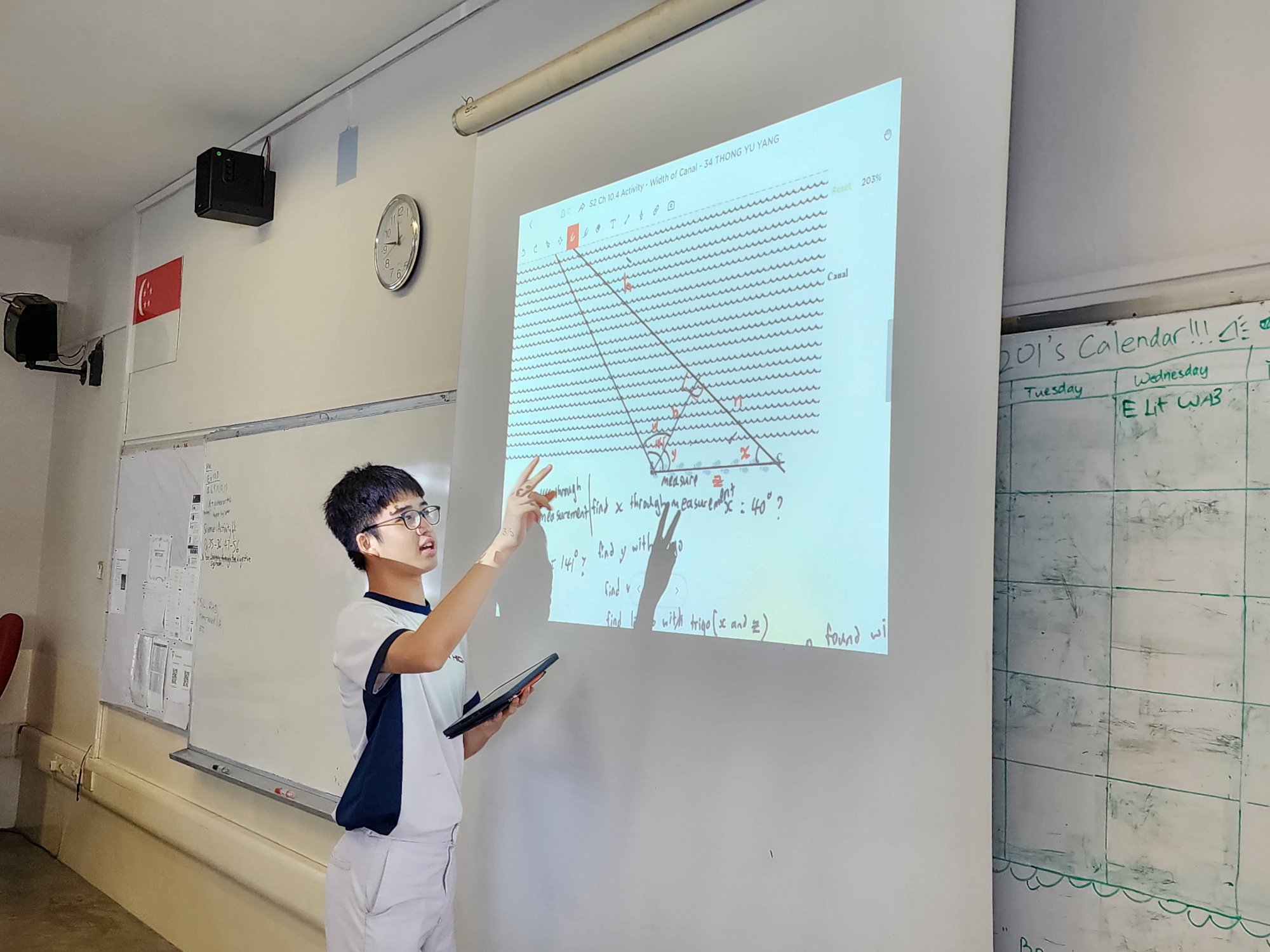 A student sharing his solution with his classmates